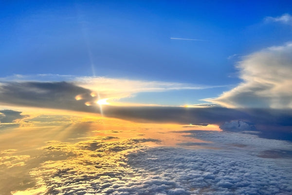 The blue sky above the clouds as the sun sets, 