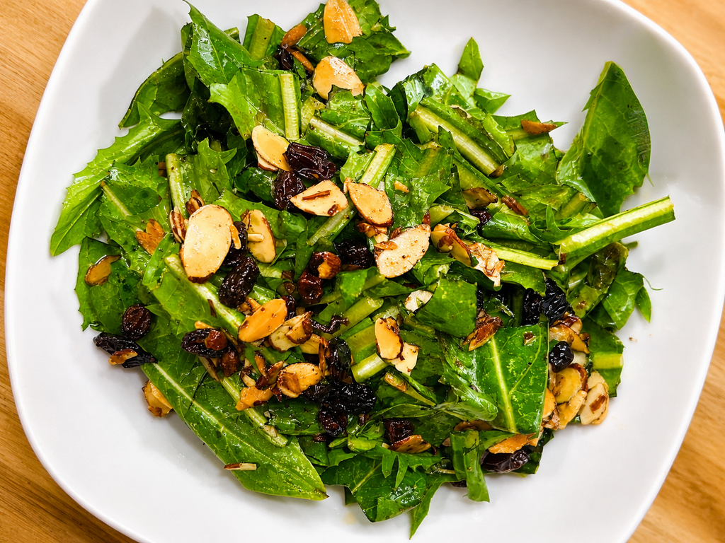 Dandelion salad with slicked almonds, raisins in a hot oil dressing