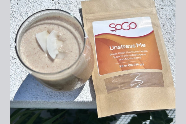SoGo Pure Unstress Me Superfood Powder with a smoothie made with Unstress Me
