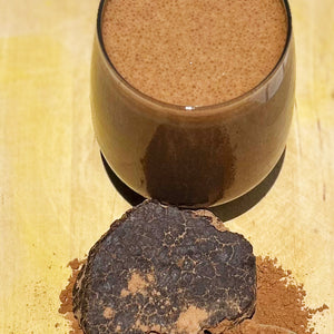 Sogo Pure Energize Cacao Shake Powder Smoothie with a block of raw cacao in front with shaved powder