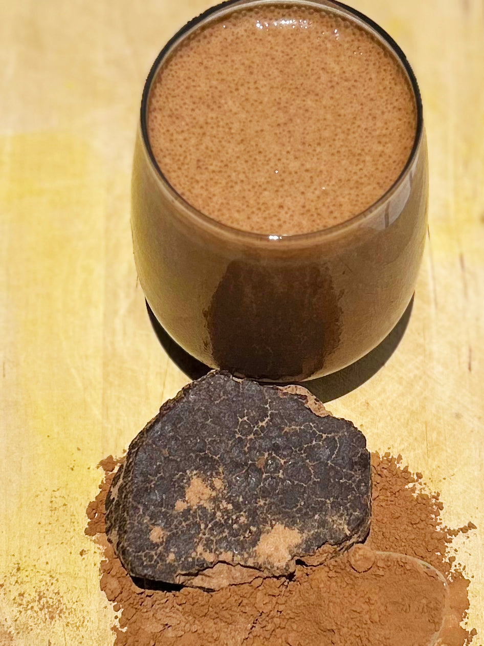 Sogo Pure Energize Cacao Shake Powder Smoothie with a block of raw cacao in front with shaved powder