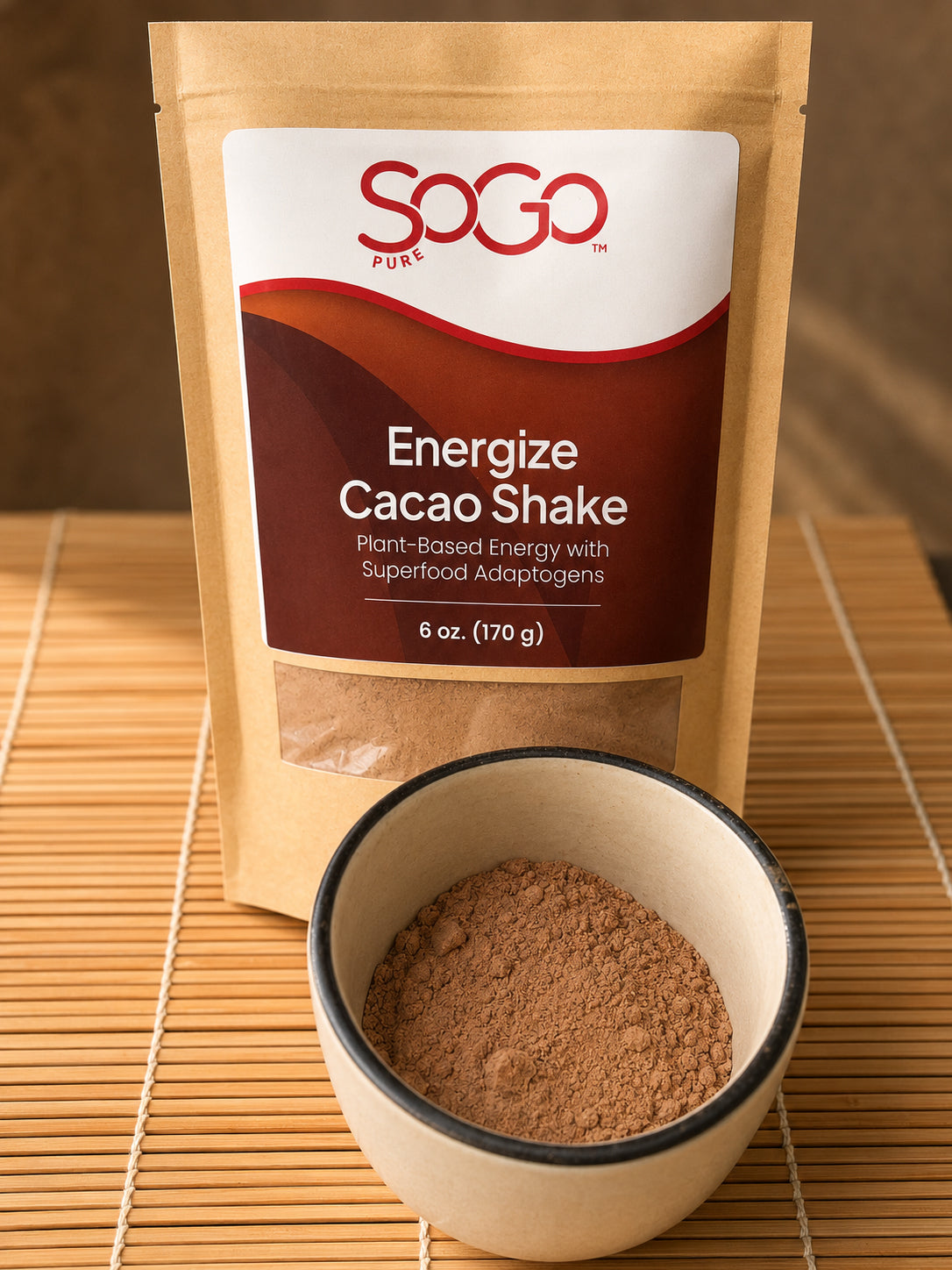 Energize Cacao Shake bag with a cup of the energize powder in front.  The items are on a straw mat