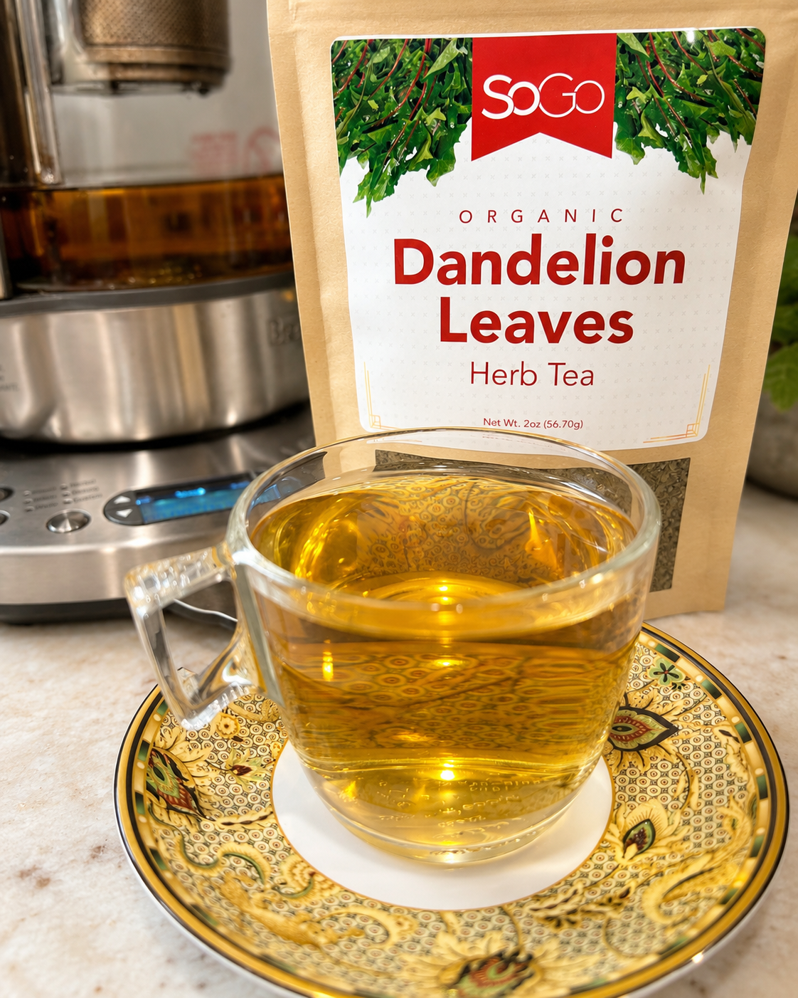 SoGo Pure Organic Dandelion Leaves, herbal tea on the counter with a cup of tea in front and the tea pot behind the bag.  